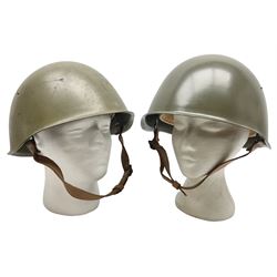 Two 1960s East Block Soviet style helmets - Czechoslovakian and Russian; both with liners (2)