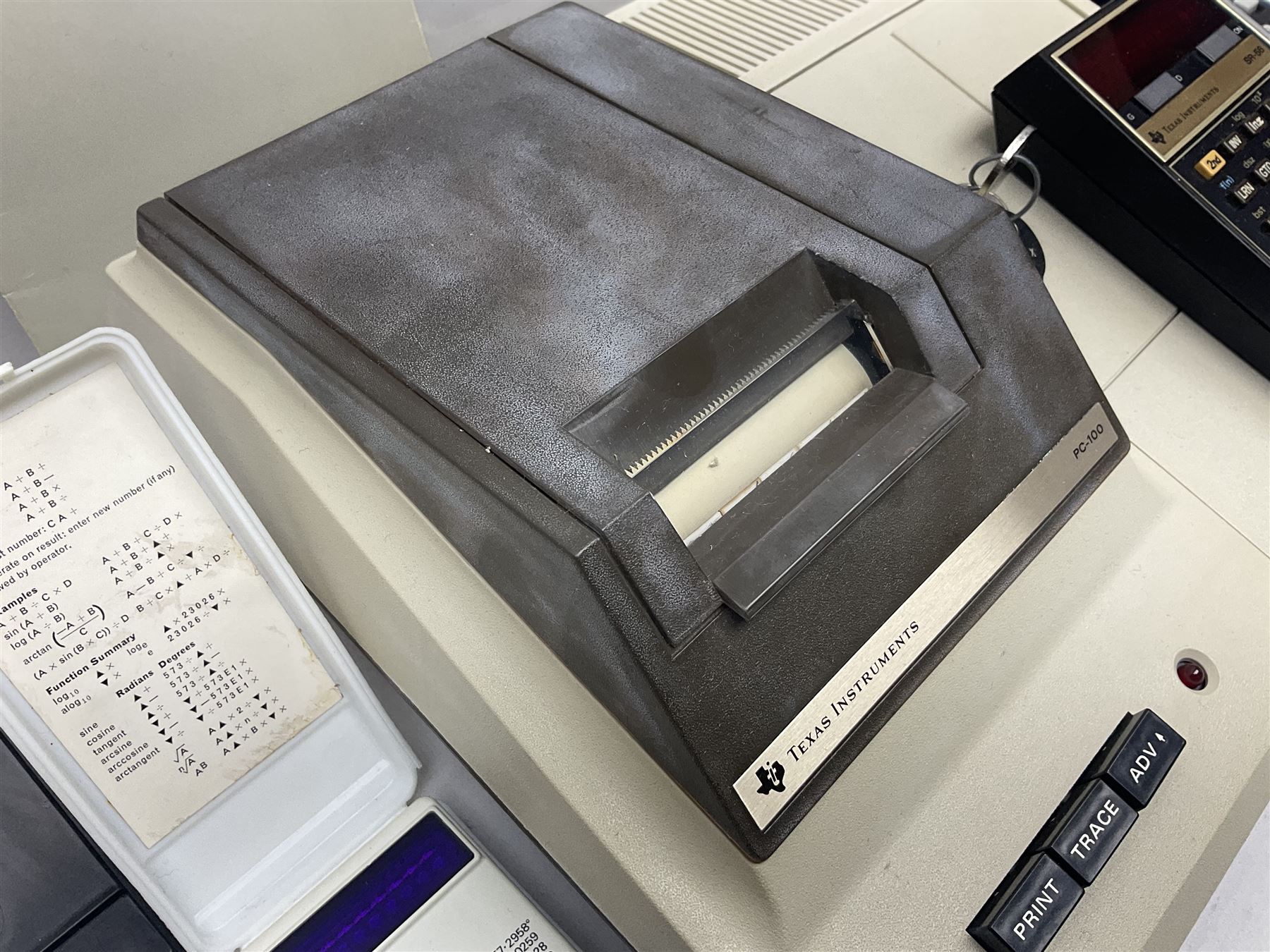 Four 1970s Sinclair electronic calculators - Cambridge in hard case with booklet; Scientific Programmable with Program Library and booklet; Scientific in hard case; and Oxford 300 in soft case with booklet; together with Texas PC-100 SR56 programmable slide-rule calculator on base station with readout, two booklets, keys and cover, serial no.9103093