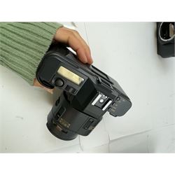 Seven Canon SLR camera bodies, comprising T50 serial no. 2011593, T70 serial no. 1319312, in carry case, two T80 examples, serial nos. 242362 & 256560, one with a Canon AC 35-70mm 1:3.5-4.5 zoom lens, and three T90 examples, serial nos. 1174363, 1005979 & 1019836, one example with a Canon FD 55mm 1:12 lens and one with a Canon FD 50mm 1:1.4 lens, one example with box