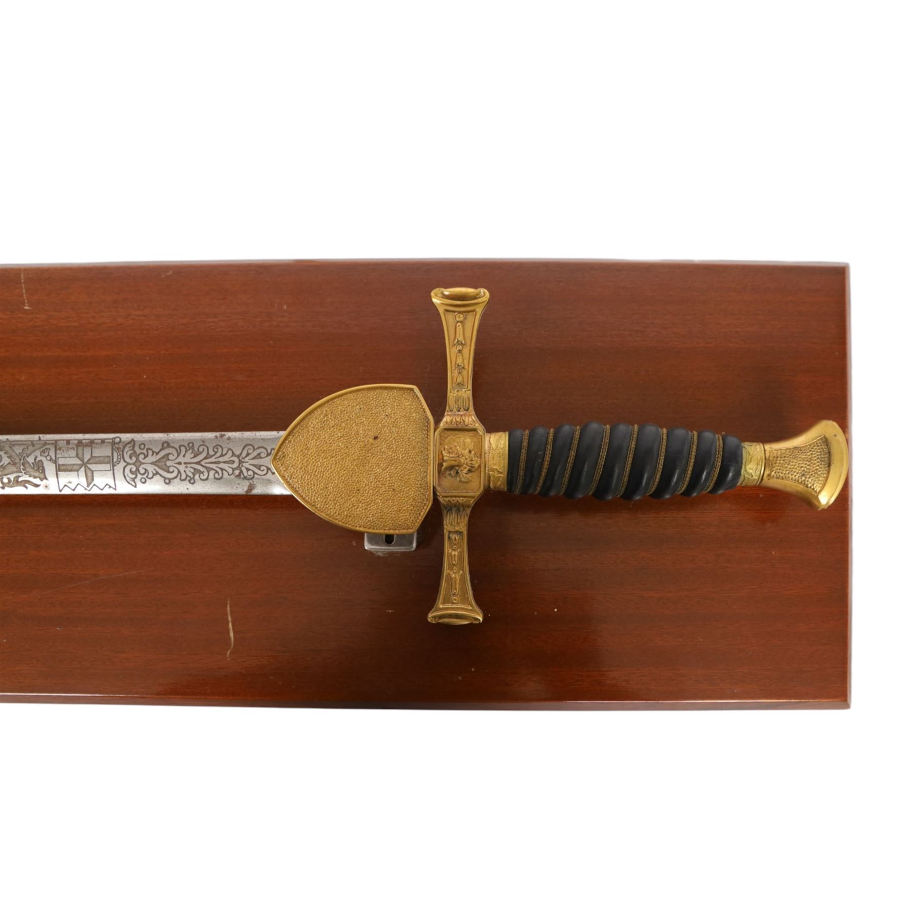 Wilkinson Sword, with 76cm double edge blade, etched with makers name and decoration, wooden grip, brass guard and hilt, together with another sword