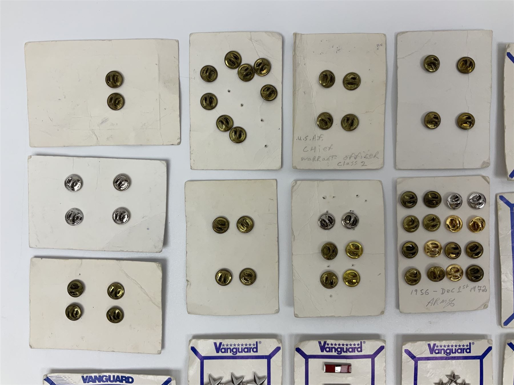 Fifty US rank badges and trade badges; WW2 and Vietnam period; predominantly on sale cards