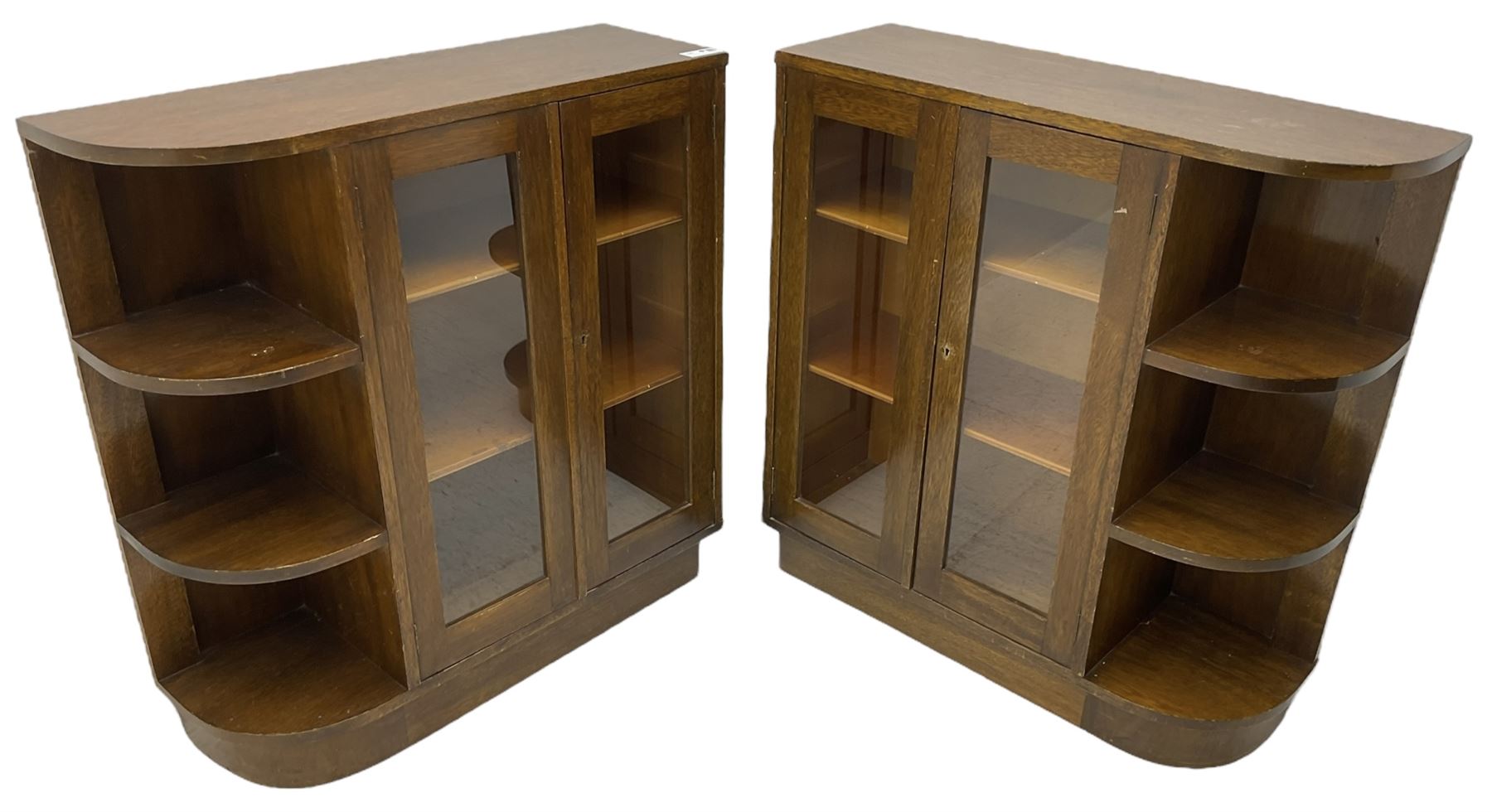 Pair of mid-20th century oak bookcases, rectangular form with curved ends, enclosed by glazed doors and fitted with shelves