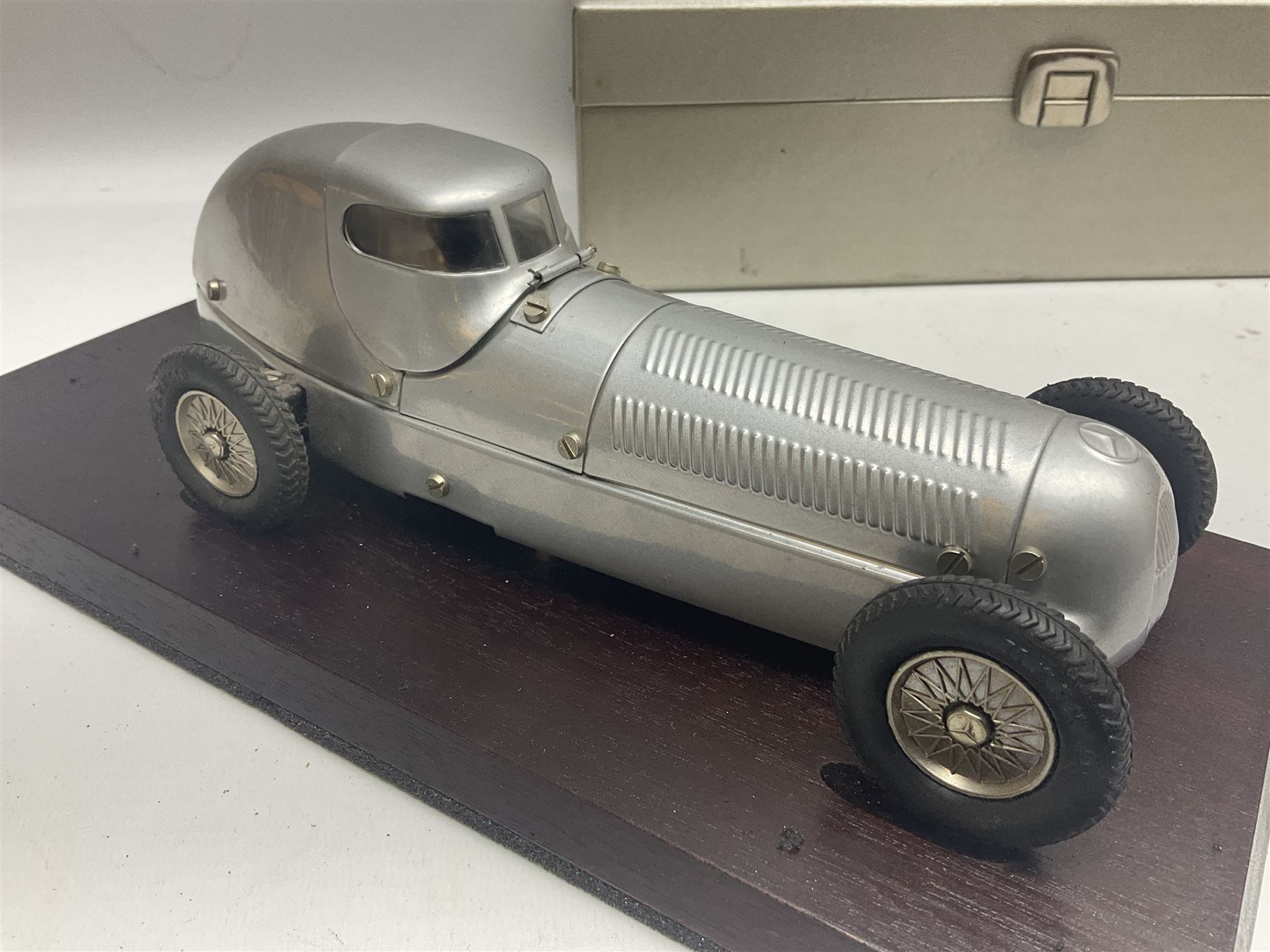 Marklin tin-plate clockwork Mercedes-Benz W25 racing car with driver in hinged cockpit model no.1096; fitted on mahogany base L33cm; in original metallic silver box with key