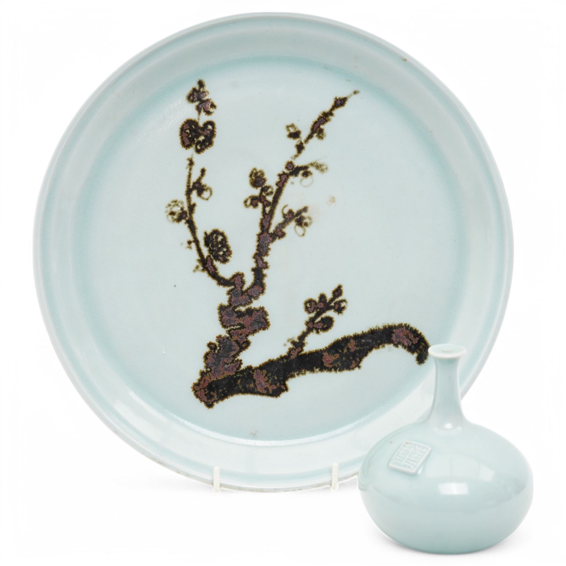 Poh Chap Yeap (Chinese/British 1927-2007); celadon glazed plate and solifleur vase, the plate decorated with a branch of cherry blossom, incised signature to bases, plate D29cm, vase H11cm (2)