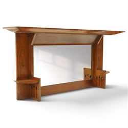 Manner of Liberty & Co, - Arts & Crafts inlaid oak overmantel mirror, the deep-projecting cornice over a rectangular plate, flanked by Art Nouveau marquetry panels of stylised tulip and foliate motifs, over a canted shelf and tulip-pierced upright