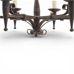 20th century wrought iron six branch chandelier, the central baluster stem issuing six scrolling arms supporting circular drip pan with drop terminals