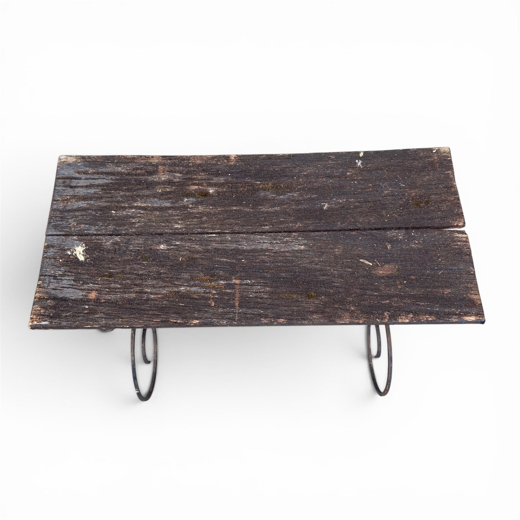Cast iron garden table, with rectangular weathered slatted wooden top, raised on iron strapwork supports of scrolling form, in black painted antique finish 