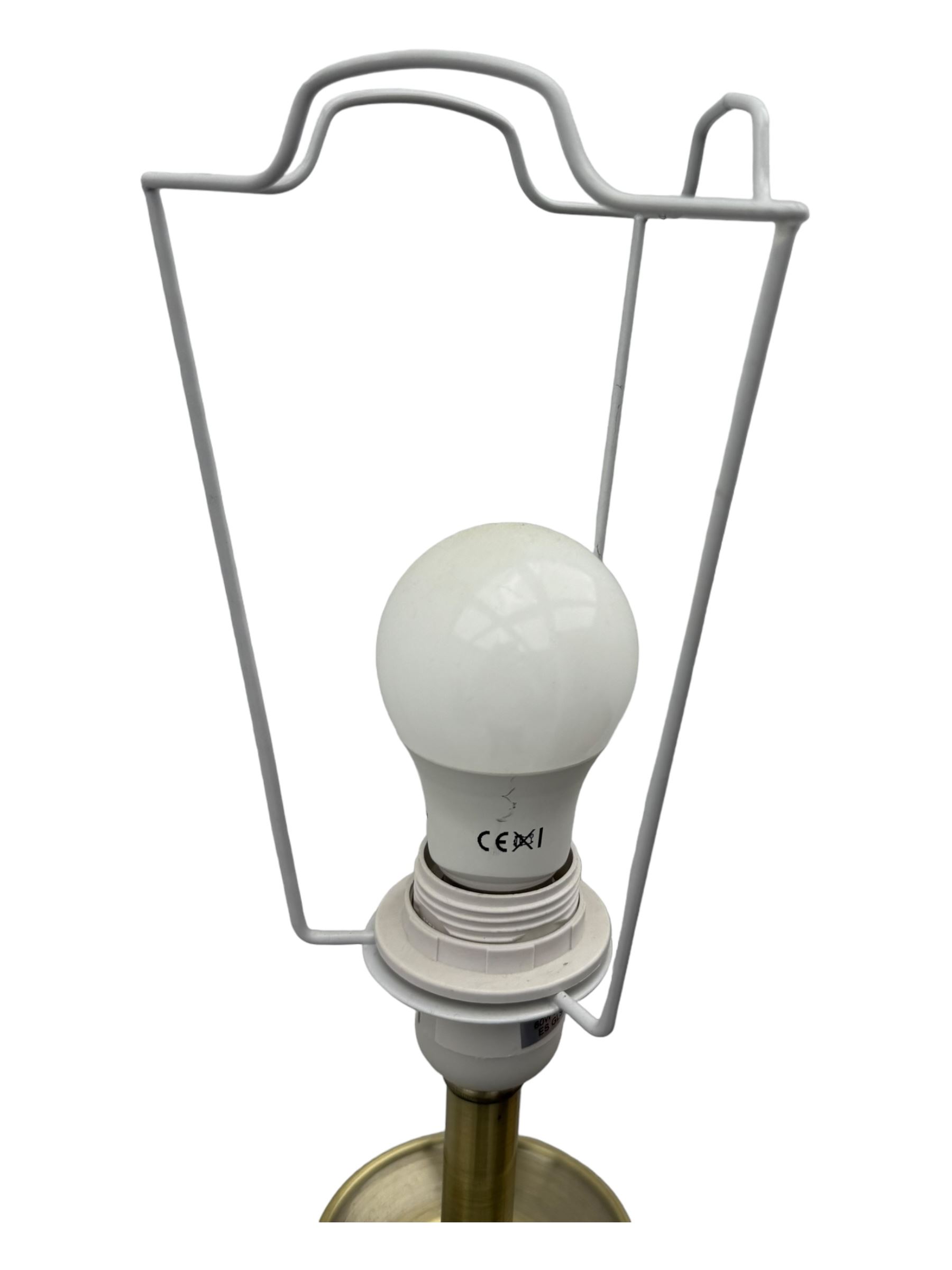 Contemporary brushed metal standard lamp, brass effect with cylindrical stem, on circular base, H131cm; matching table lamp, H35cm (2)