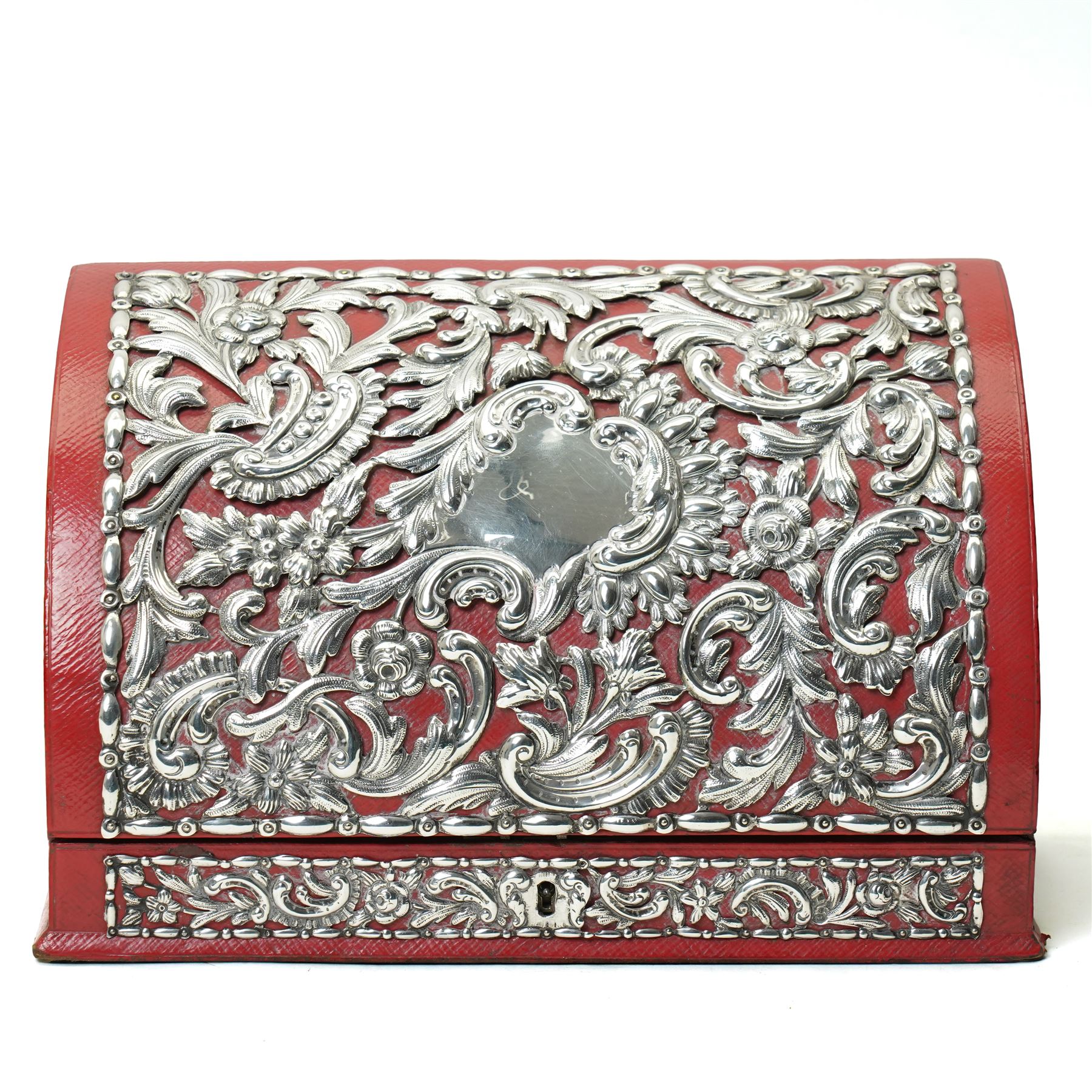 Late Victorian red leather stationery casket with divided watered silk interior, the hinged front with repousse silver mounts H19cm x W30cm London 1889 Maker William Comyns