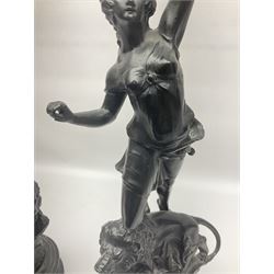Pair of spelter figures, Le Force and Le Pouvoir, modeled as figures standing on lions, arms held aloft, H51cm 