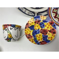 Modern studio pottery by Josie Firmin, to include cup and saucer, three espresso cups and saucers, pair of egg cups etc, each hand painted with varying cartoon cat designs