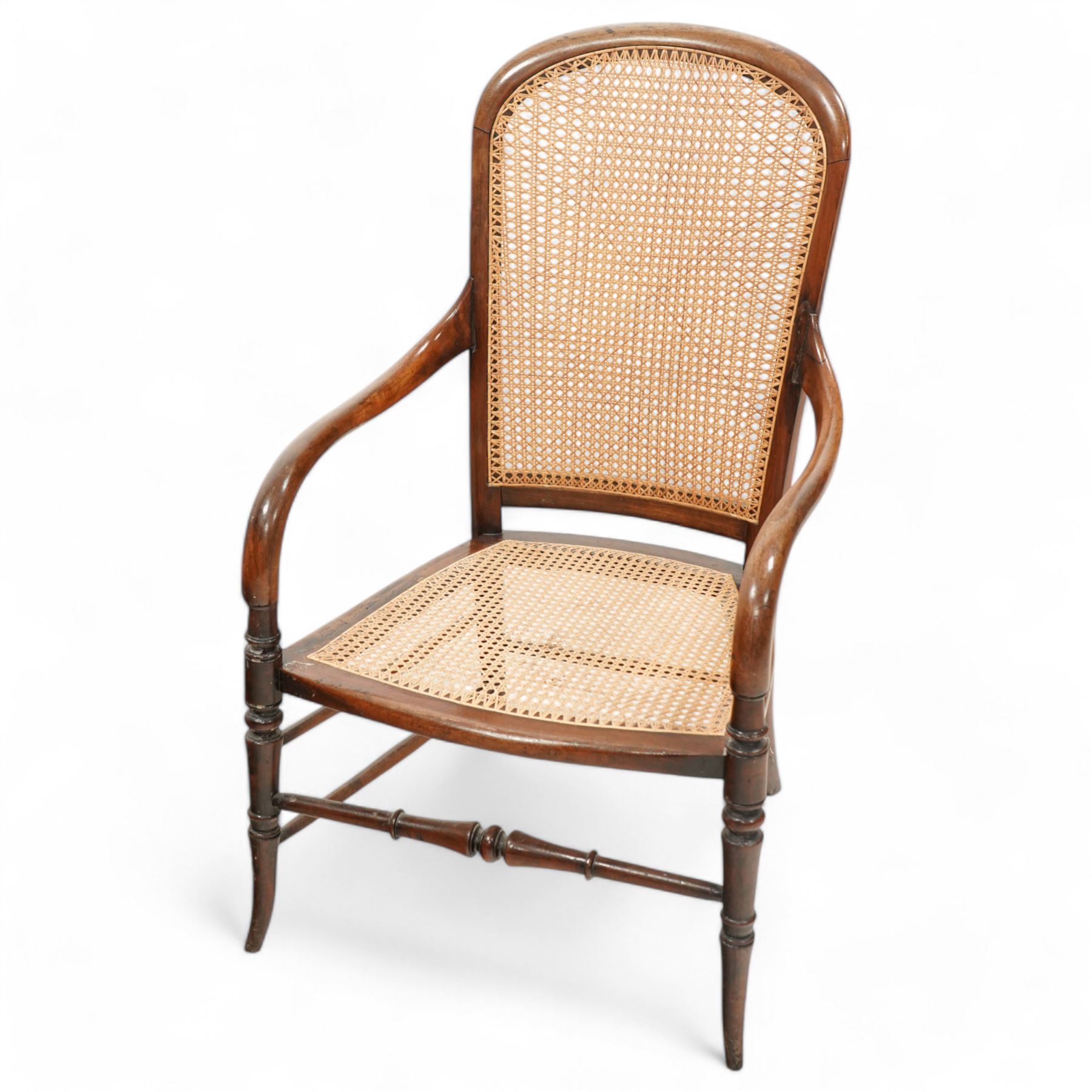 Victorian stained beech frame open armchair, arched cane work back and seat, on turned supports with splayed feet united by turned stretchers 