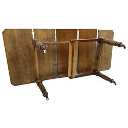 Late Victorian oak telescopic extending dining table, rectangular moulded top with canted corners, three additional leaves, on turned and reeded supports with brass and ceramic castors