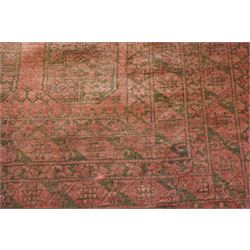 Afghan crimson ground Bokhara rug, the field with three rows of repeating Gul motifs, within six concentric guard bands decorated with repeating geometric patterns