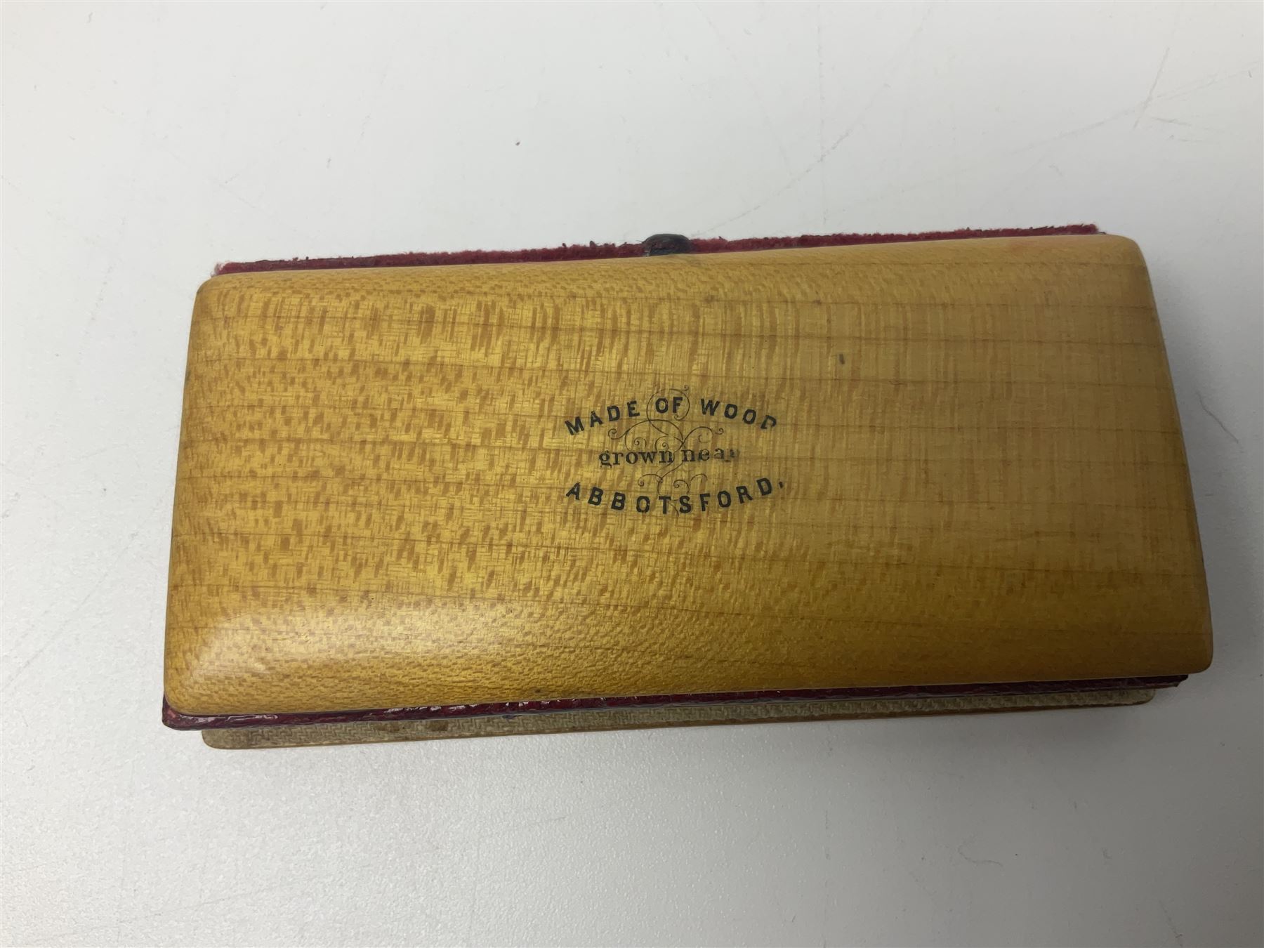 Six sewing related Mauchline ware comprising an oval reel box with internal label for Clark & Co's, tape measure, pin case and three thimble holders of ovoid form 