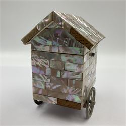 19th century French souvenir jewellery casket in the form of a bathing machine, having mother of pearl panelled tiled effect body, hinged roof/cover revealing a blue silk fitted interior with cushioned base, two silvered metal wheels, abalone shell door and mother of pearl steps, inscribed 'Berck Plage' in blue, H12cm, W13cm 
