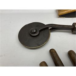 Thirty-one bookbinder's brass number and letter stamps, predominantly with beech handles, together with a bookbinder' decorative fillet roll, with brass triple line wheel stamped E. Menuel London, with wood handle, and two ink blotters