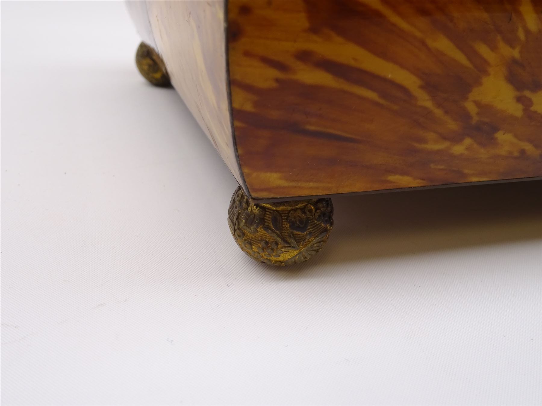 19th century tortoiseshell sewing box, of sarcophagal form upon four foliate detailed brass ball feet, the hinged cover edged in ivory with initialled silver plaque to centre, opening to reveal a silk lined interior, H9.5cm W22.5cm D18cm