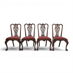 Chippendale design set of ten (8+2) mahogany dining chairs, serpentine cresting rails with carved detail over pierced ribbon-tied splats, red damask upholstered drop-in seats, on cabriole supports with acanthus carved knees and claw and ball feet