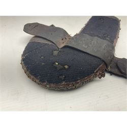 Eastern Jambiya, the 19cm double edge steel blade with raised medial ridge, waisted horn grip with pique work and white metal band; in stitched leather scabbard L33cm overall
