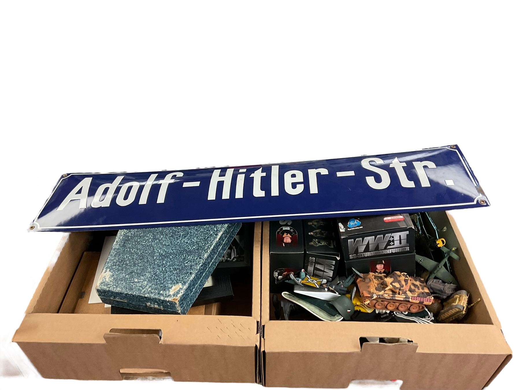 Collection of replica German WWII items, including solider figures, street sign etc, in three boxes 