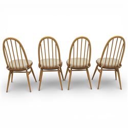Ercol - elm dining chairs, set of six including two armchairs, arched spindle backs over shaped elm seats with upholstered pads, tapering beech legs joined by stretchers