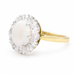 18ct gold opal and diamond cluster ring, oval cabochon cut opal surrounded by twelve single cut diamonds, London 1988