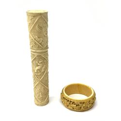 An early 20th century carved ivory bodkin case, carved in low relief with lozenges containing shells, seed pods and birds, and figures, containing four bodkin needles, H11.5cm, together with an early 20th century Chinese carved Canton napkin ring, D4.5cm. 