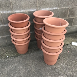 Fifteen tapering terracotta pots, H31cm