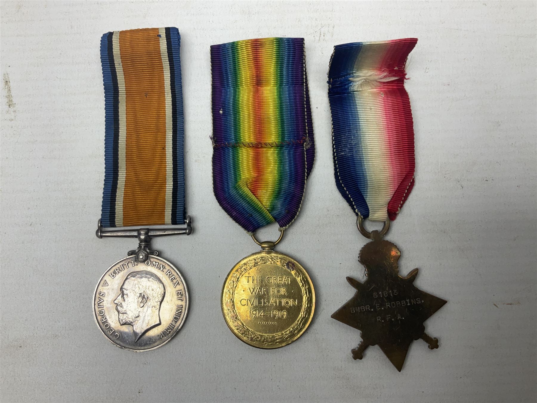 WW1 group of three medals comprising British War Medal, 1914-15 Star and Victory Medal awarded to 61813 Bmbr. E. Robbins R.F.A./R.A.; with ribbons