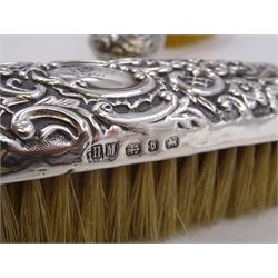 Group of silver, comprising Victorian silver hair brush and matching clothes brush, with repousse floral and scroll decoration, and each engraved with lion rampant to central cartouche, hallmarked Henry Matthews, Birmingham 1895, together with a 1920s miniature silver mounted photograph frame, hallmarked Charles Edwin Turner, Birmingham 1925 H7cm, and a Georgian silver Hanoverian pattern teaspoon, with scroll decoration to underside of bowl and engraved initials verso, hallmarks worn and indistinct