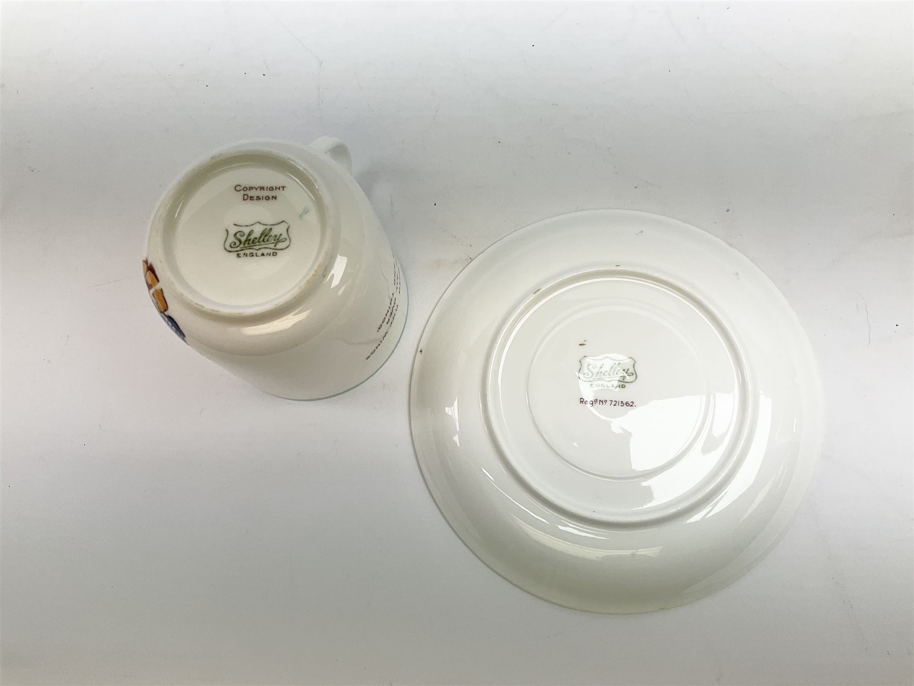 Shelley Boo Boo three piece tea set designed by Mabel Lucie Attwell, comprising teapot modelled as a house, sugar bowl modelled as a toadstool, and creamer modelled as an elf, each with printed marks beneath, together with a Shelley Mabel Lucie Attwell teacup and saucer. 