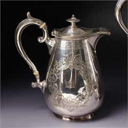 Pair of large silver plated sauce boats with bead edge decoration and C scroll handles engraved with a crest in the form of a winged heart and on shaped supports L20cm Maker probably Hawksworth Eyre & Co and an engraved hot water jug and a matching smaller jug with the same crest and by the same maker