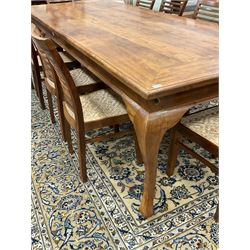Large teak dining table, moulded rectangular top, on cabriole supports, together with a set of ten ladder back dining chairs with cane work seats