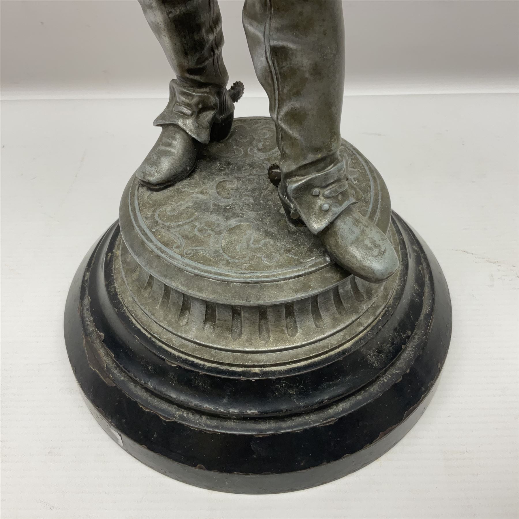 Spelter figure modeled as Cavalier with a raised sword, upon a circular base, H52cm