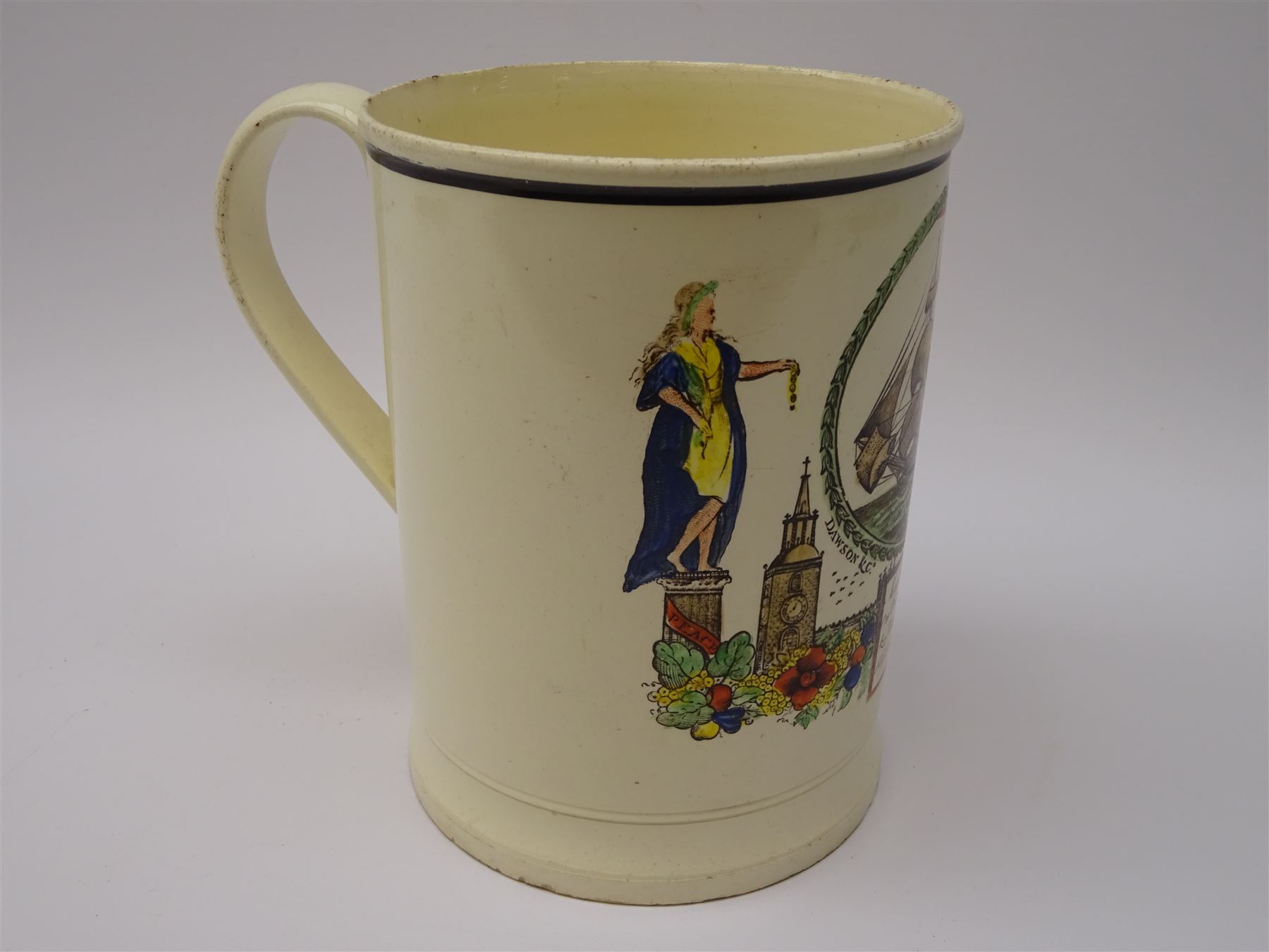 Early 19th century Sunderland Dawson & Co creamware pottery mug, the cylindrical body black transfer printed and polychrome detailed with a circular panel of a three-masted ship flanked by two figures of Peace and Plenty, above a panel containing verse 'May Peace with Plenty on our Nation smile [...]' H15cm D11cm