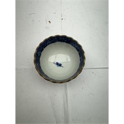 Pair of Staffordshire figures modelled as chained Dalmatians seated upon cobalt blue oval bases, H13cm, together with a Staffordshire pastille burner modelled as a castle, H12cm, a pair of 19th century Derby potpourri pots (lacking covers), and an 18th century blue and white tea bowl 