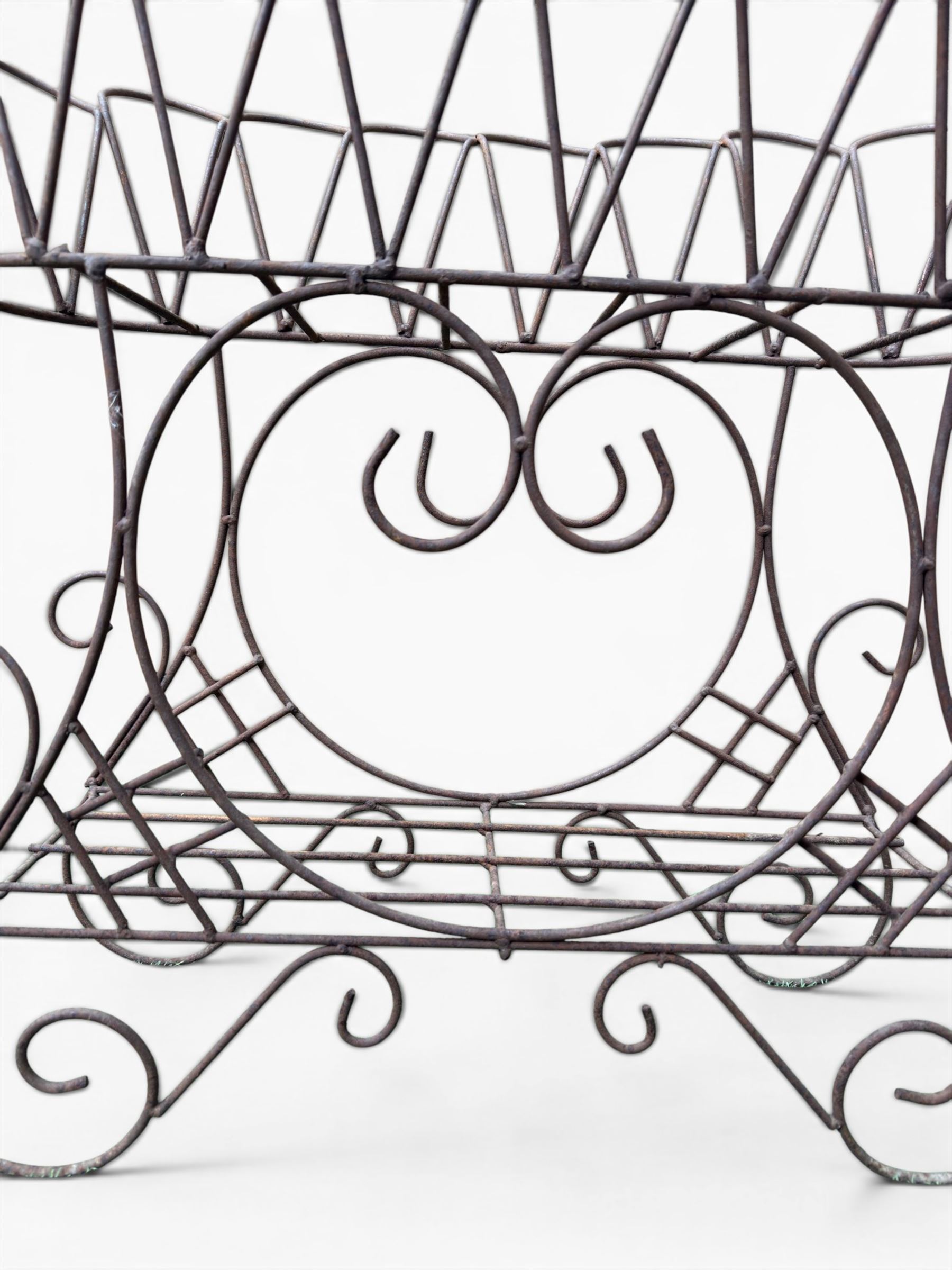 Mid-20th century wirework garden planter, oval form with heart shaped centre, under-tier shelf above scrolling feet