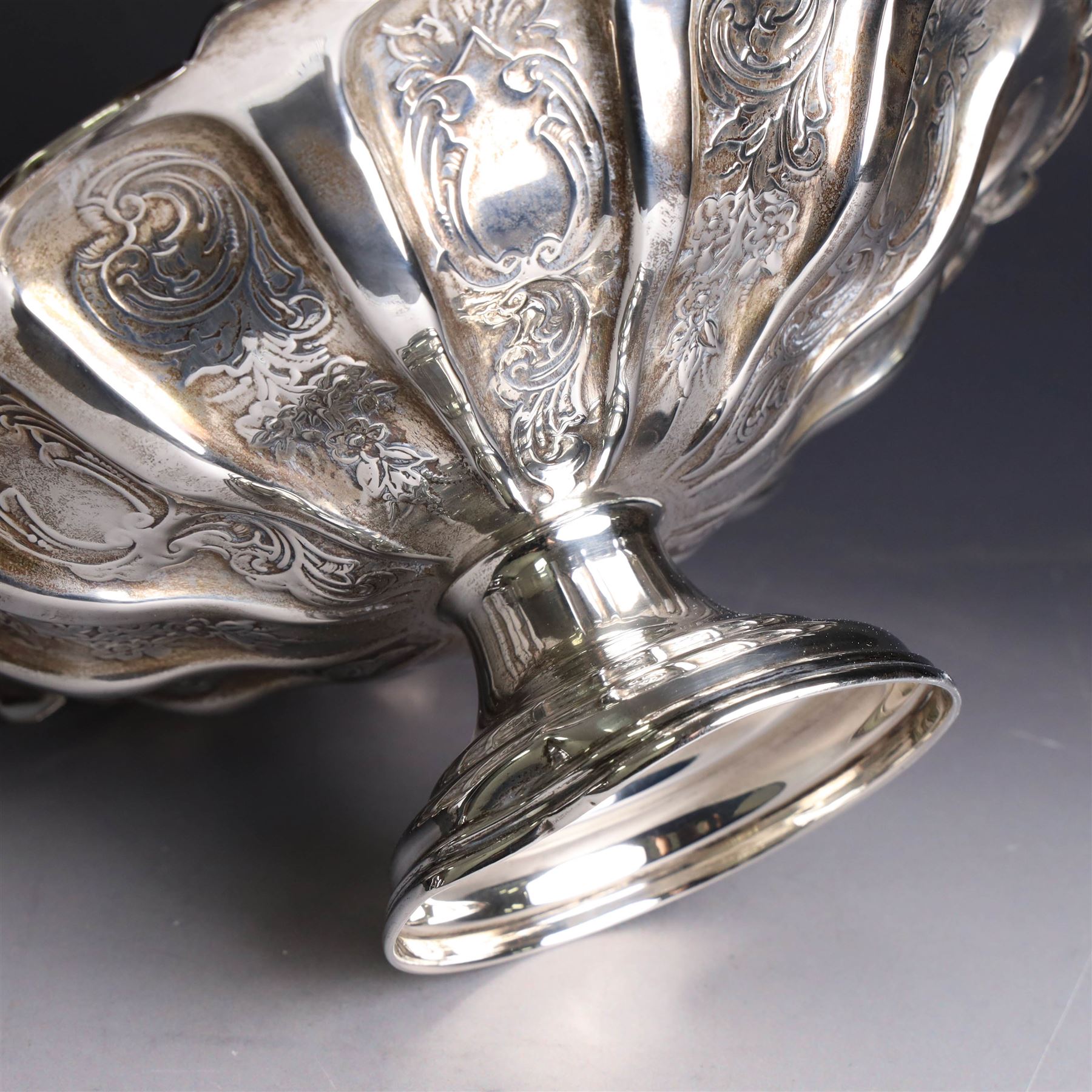 Edwardian silver swing handled basket, of circular form with shaped rim and engraved floral and foliate decoration, with know design swing handle and upon circular stepped pedestal, hallmarked J Sherwood & Sons, Birmingham 1901, H9cm, D22cm