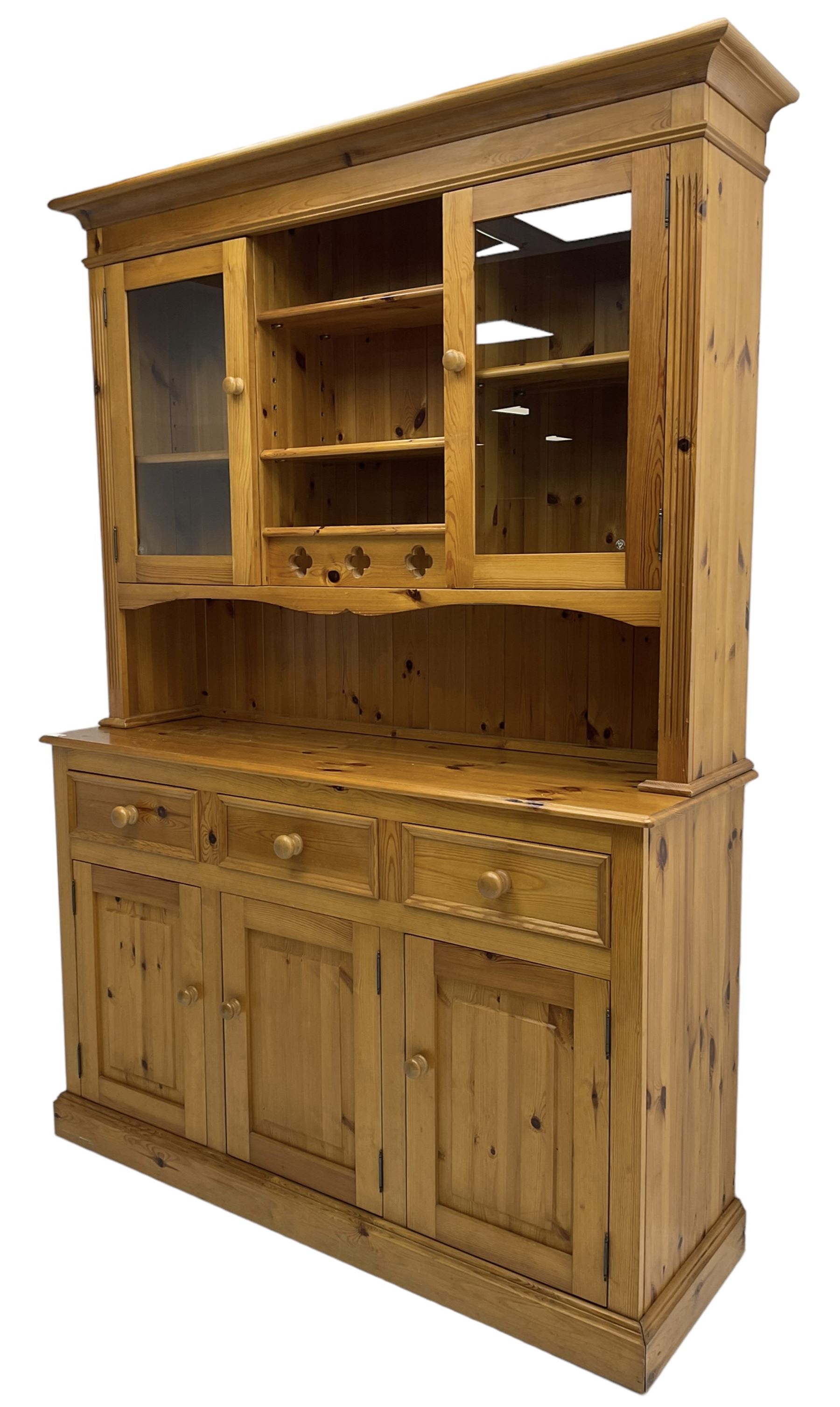 Traditional pine dresser, the rack fitted with two shelves flanked by glazed cupboards, the base with three drawers over three panelled cupboards