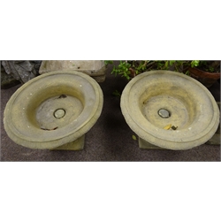  Pair composite stone urn planters, circular form with egg and dart rim and gadroon underside, on tapered pedestal bases, D62cm  