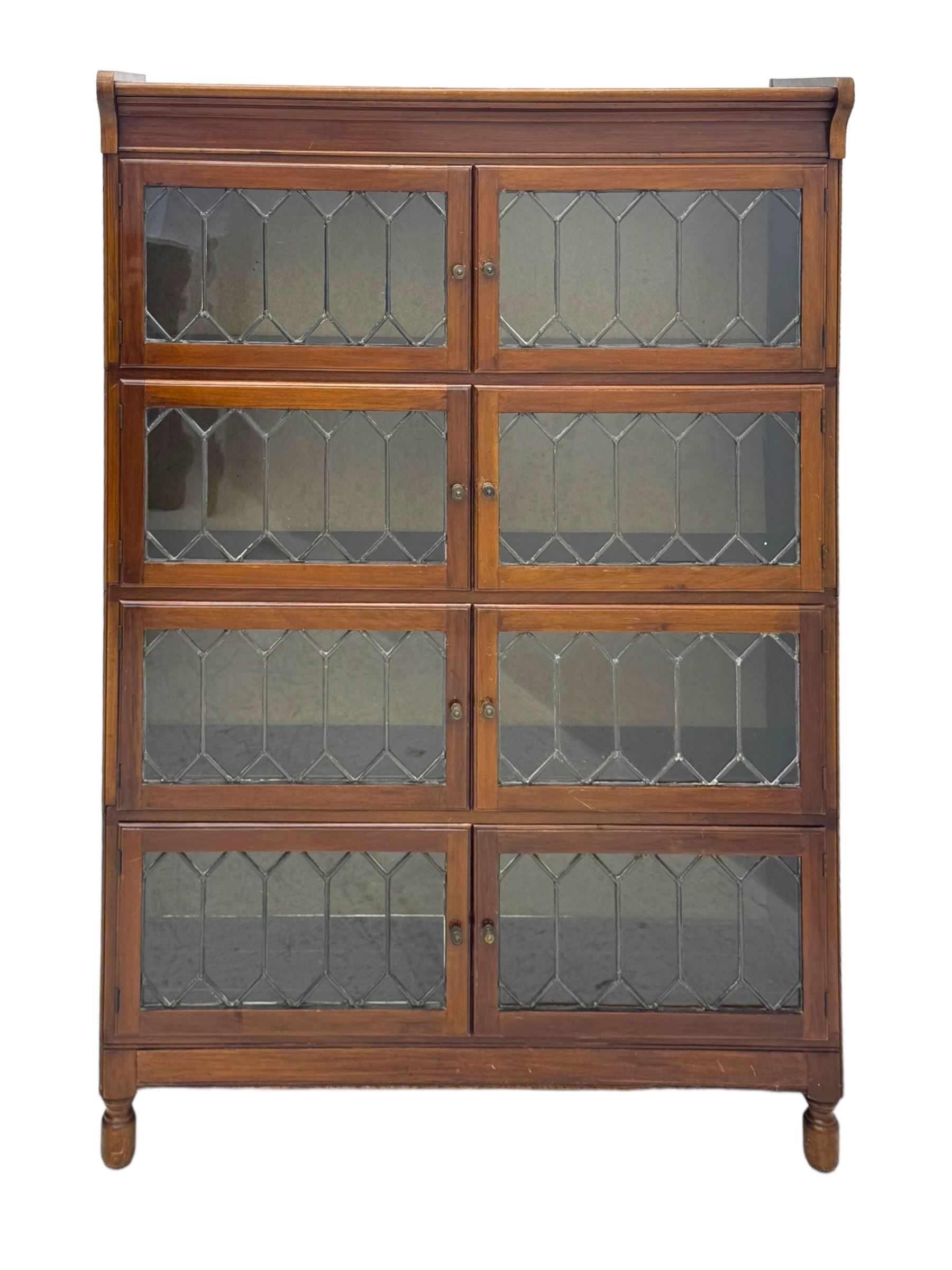 Early 20th century Globe Wernicke design stacking walnut bookcase, fitted with four sections each with two leaded glass doors, raised on turned feet