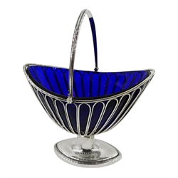 George III silver sugar basket, boat shaped design with openwork sides, swing handle and original blue glass liner by Nathaniel Smith & Co, Sheffield 1799