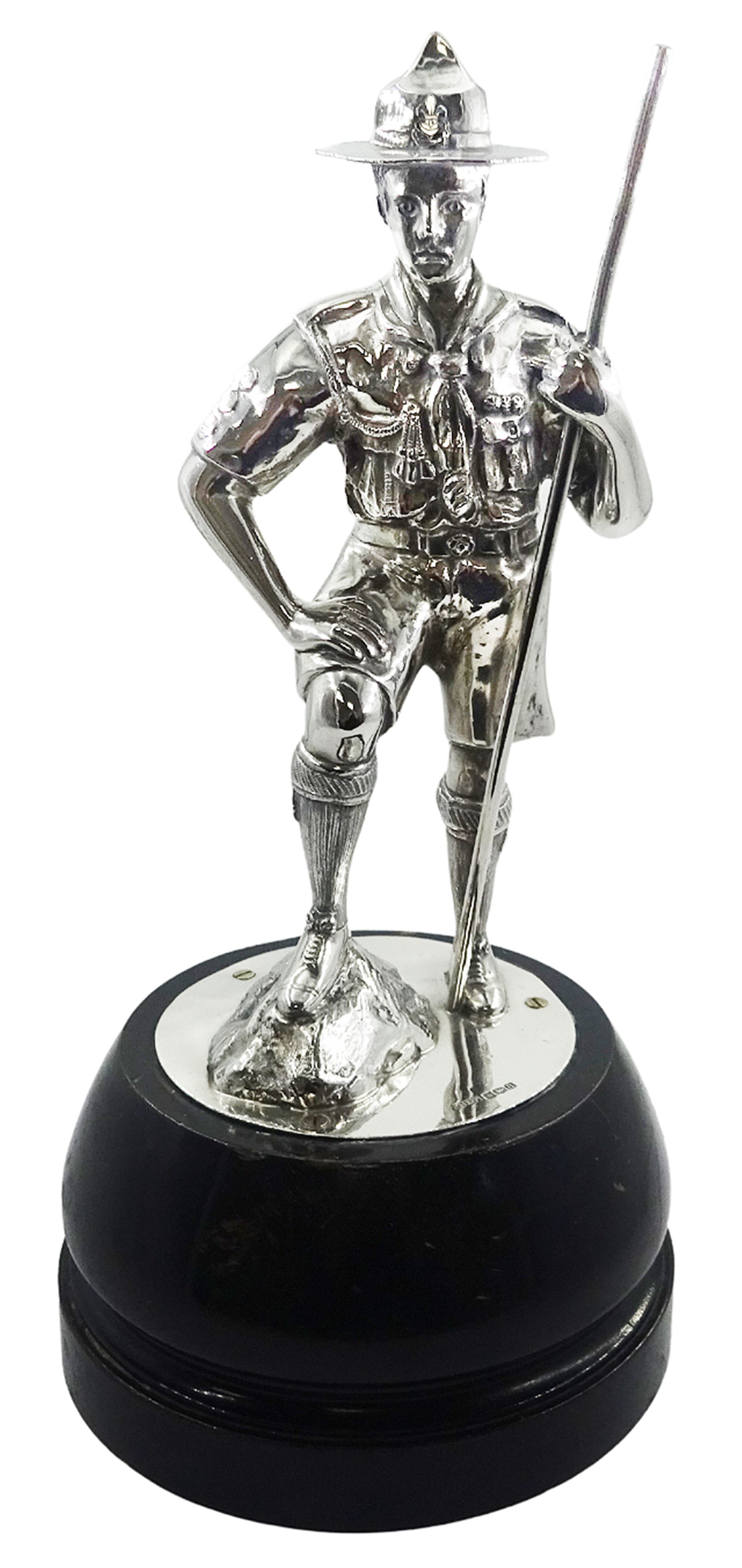 1930's silver model of an American boy scout, in full uniform, with one foot raised upon rocky modelled ground, hallmarked Gladwin Ltd, Sheffield 1930, upon an ebonised circular base, overall H31cm 