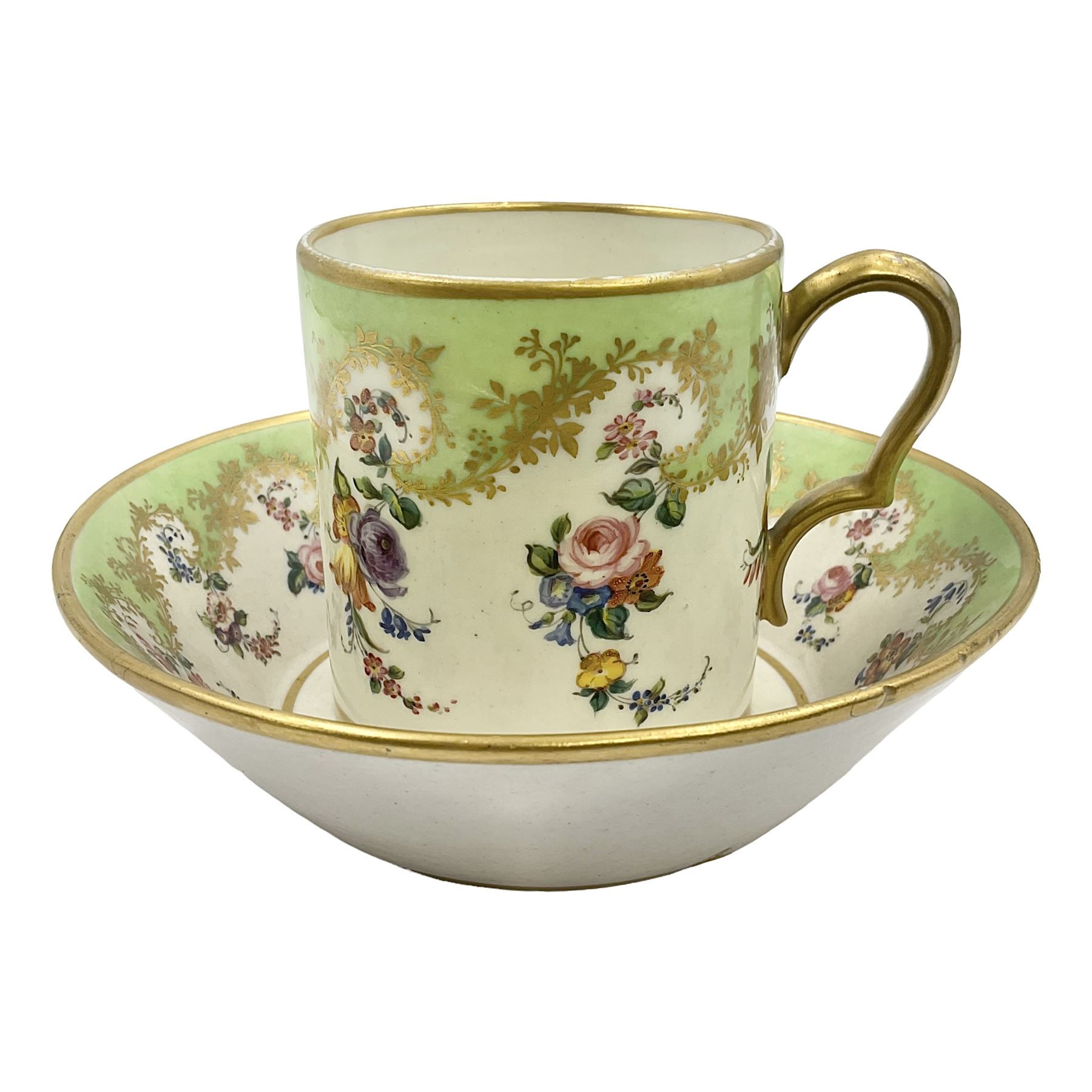 Sèvres soft paste porcelain coffee can and saucer with date code for 1754, painted and gilded with flowers, dangling from the shaped green border, interlaced LL monogram enclosing the date letter A above painters mark for Dodin, coffee can H7cm, saucer D14.5cm