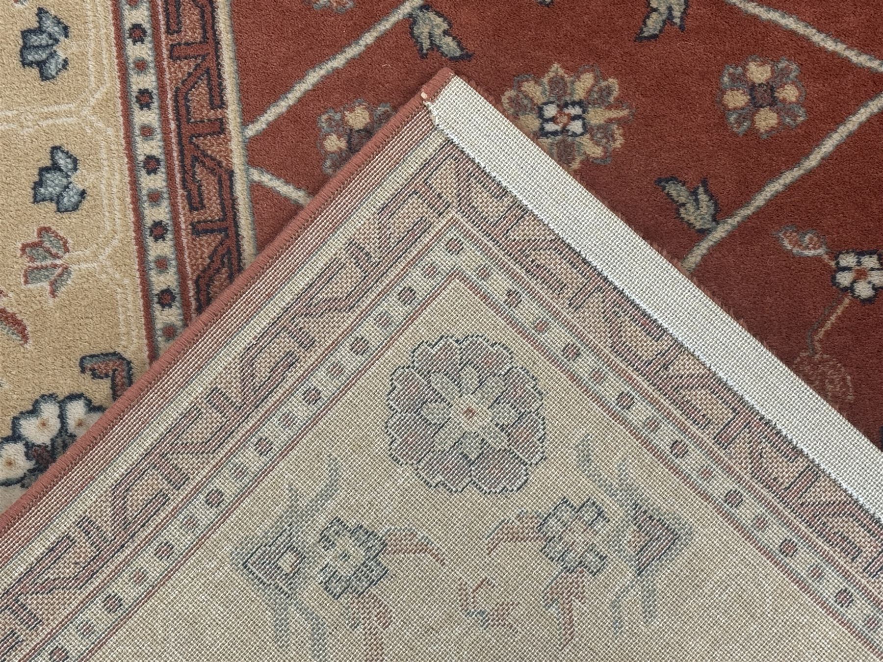 Late 20th century Royal Keshan 'Agra' hand-knotted wool rug, terracotta ground with central floral medallion and scrolling vines, enclosed by a cream border with repeating floral motifs