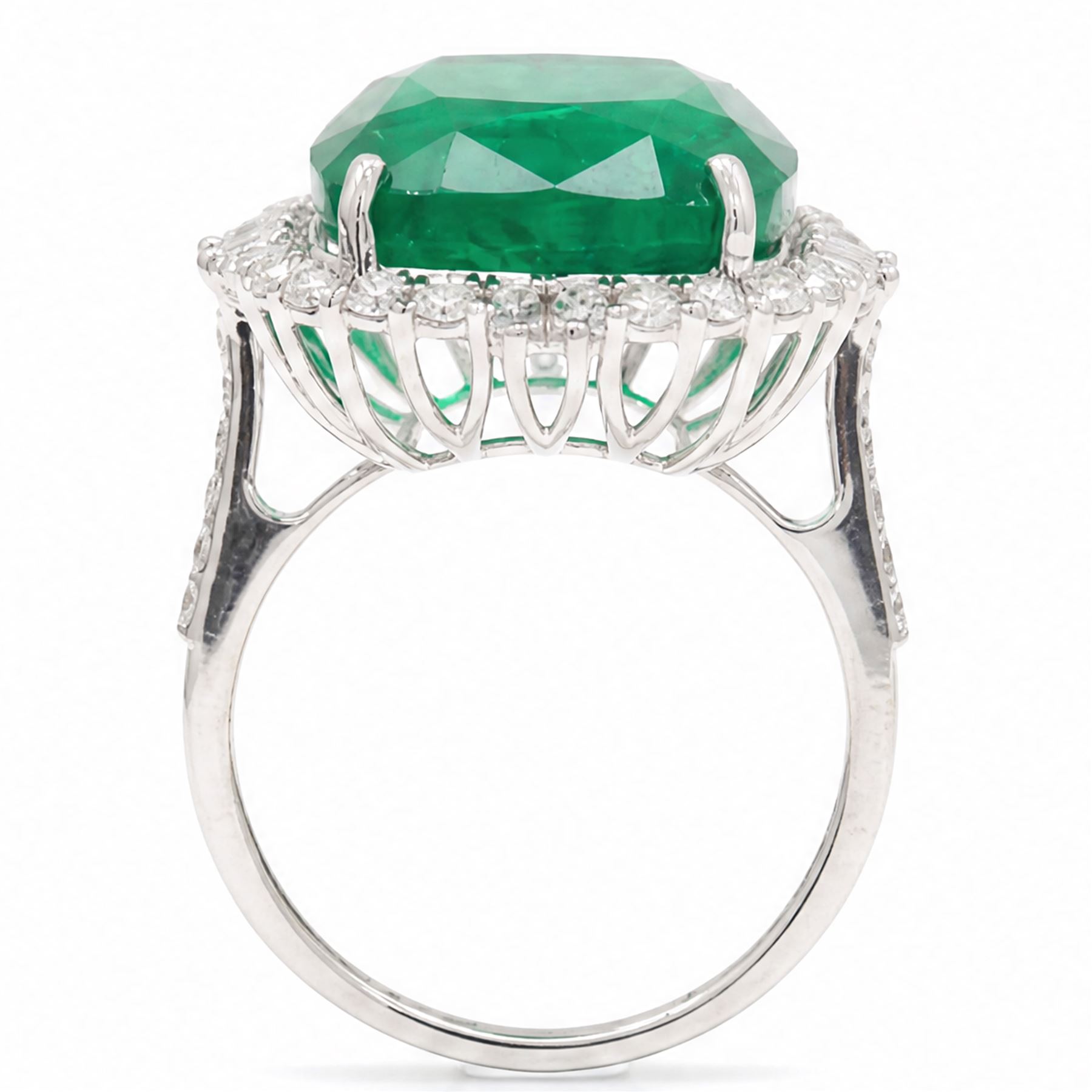 18ct white gold emerald and diamond cluster ring, single cushion cut emerald of approx 13.20 carat, surrounded by round brilliant and baguette cut diamonds and diamond set shoulders, stamped 18K, total diamond weight approx 1.00 carat