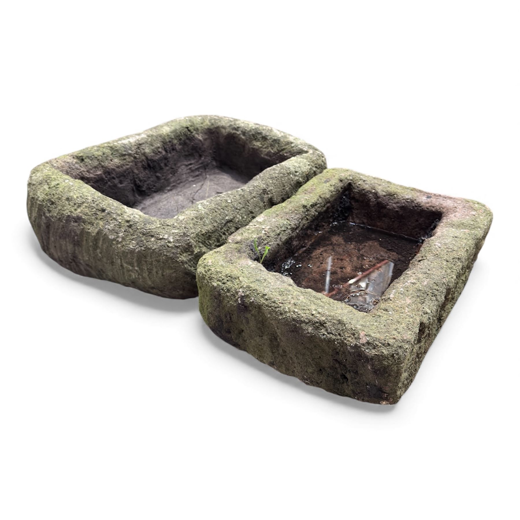 Two 19th century stone troughs, with mill stone, flagon and metal milk churn 