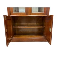 Grange Furniture - cherry wood finish display cabinet, two bevel glazed doors enclosing mirrored interior with glass shelves, double panelled cupboard below, on plinth base