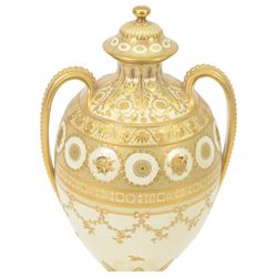 Royal Crown Derby twin handled vase and cover, circa 1886, decorated with raised and tooled gilt borders of foliate scrolls and husk swags upon a cream ground, H38cm